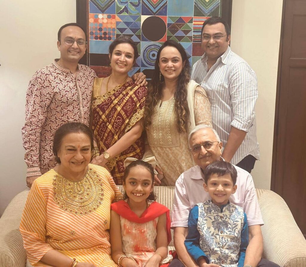 A warm family portrait of Dr. Rajeev Biyani at his Akola home, with his wife, sons, daughters-in-law, and grandchildren—capturing a moment of togetherness across generations.
