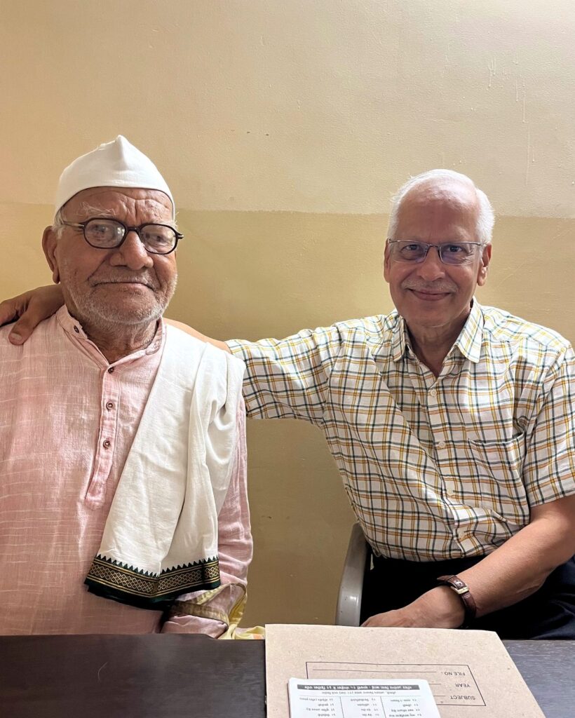 Dr. SP Kalantri sitting alongside Babulal at MGIMS Hospital, Sevagram